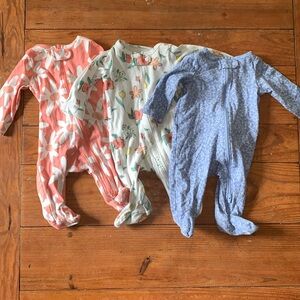 Three 3-month Carter’s long sleeved, two-way zippered onesies
